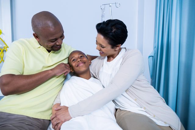 Smiling parents interacting with patient in hospital