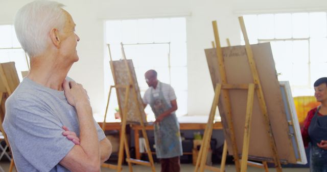 Senior Man Observing Students During Art Class in Bright Studio - Download Free Stock Images Pikwizard.com