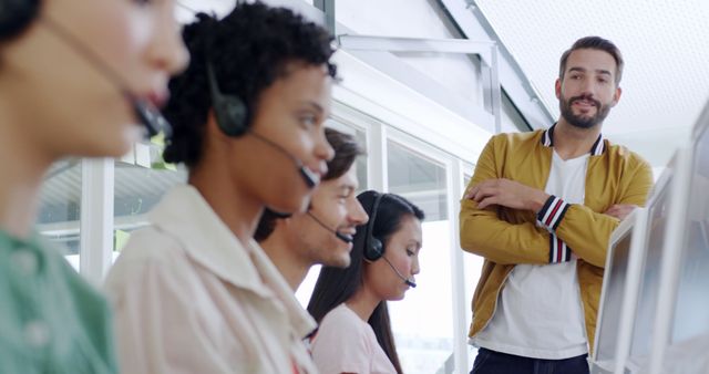 Customer Service Team Working in Call Center with Supervisor Overlooking - Download Free Stock Images Pikwizard.com