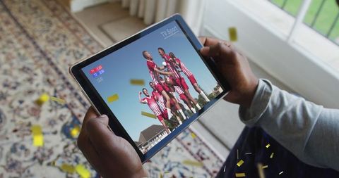 Viewing Sports Team Celebration on Tablet with Falling Confetti - Download Free Stock Images Pikwizard.com