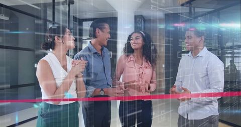 Colleagues celebrating ribbon cutting and networking in modern glass office lobby