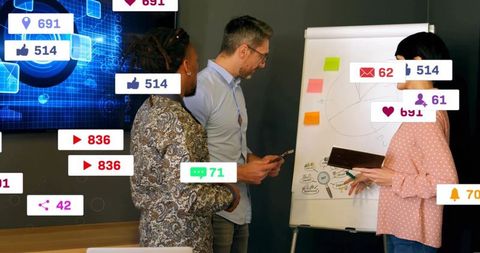 Team collaborating around flipchart with social media analytics overlay and engagement badges