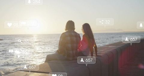 Couple Observing Ocean Sunset with Social Media Overlays