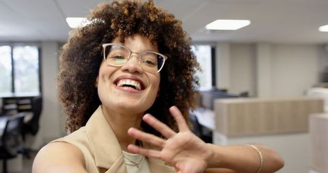 Smiling Businesswoman Taking Selfie in Modern Office Environment