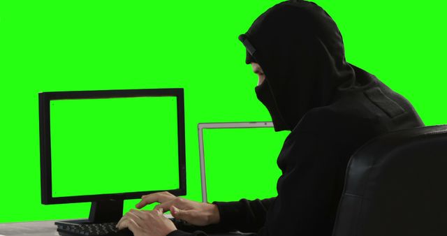 Anonymous Hacker in Hood Working on Computer with Green Screen - Download Free Stock Images Pikwizard.com