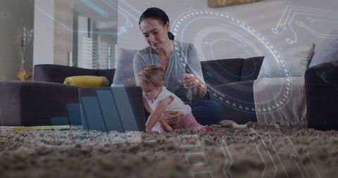 Mother bonding with baby while using tablet with futuristic technology overlay in living room