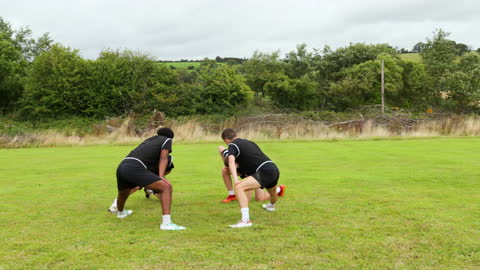 Soccer Players Warming Up on Green Field Prepares for Practice