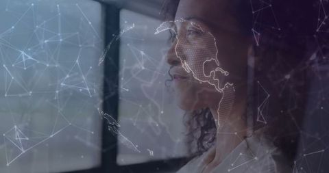 Businesswoman viewing futuristic network map against window