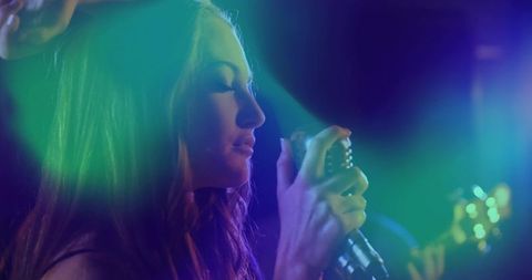 Moody Neon Female Stage Singer Holding Vintage Microphone Close-Up