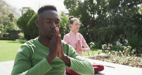 Diverse Couple Practicing Yoga Outdoors in Serenity