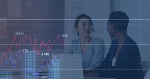 Diverse Female Coworkers Analyzing Report with Data Overlay