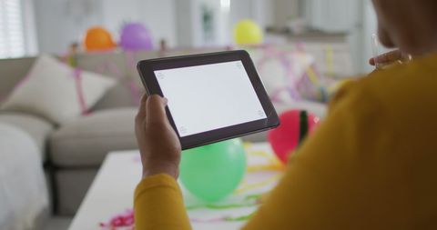 Senior Woman Using Tablet for Video Call During Cozy Home Celebration - Download Free Stock Images Pikwizard.com