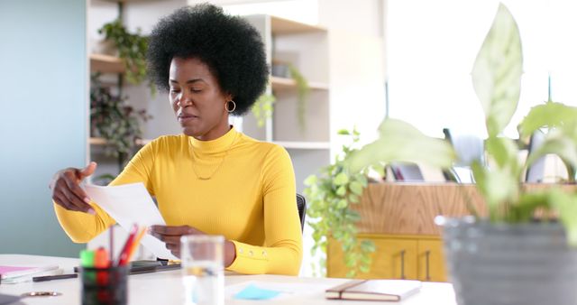 Focused Woman in Yellow Sweater Working at Desk - Download Free Stock Images Pikwizard.com