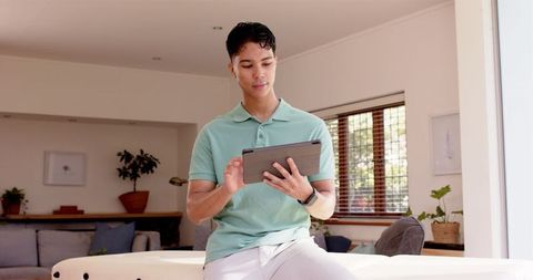 Young Professional Using Tablet in Modern Home