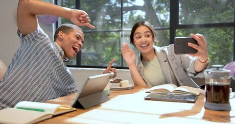 Cheerful Colleagues Taking Selfie at Office Celebration with Technology