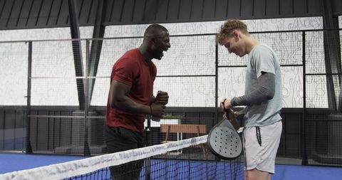 Diverse Male Friends Laughing on Padel Court