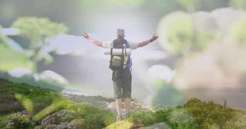 Senior man celebrating nature on hiking adventure