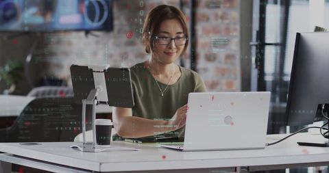 Asian Businesswoman Processing Data in Modern Office