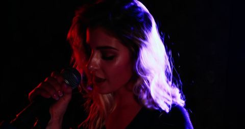 Passionate Female Singer in Vibrant Stage Lighting - Download Free Stock Images Pikwizard.com