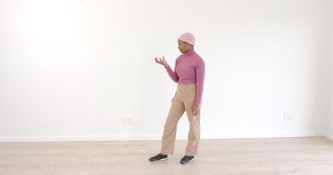 Woman Practicing Dancing Moves in Minimalist Room