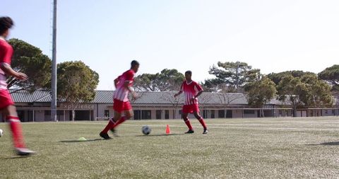 Teen soccer players practicing drills for team development
