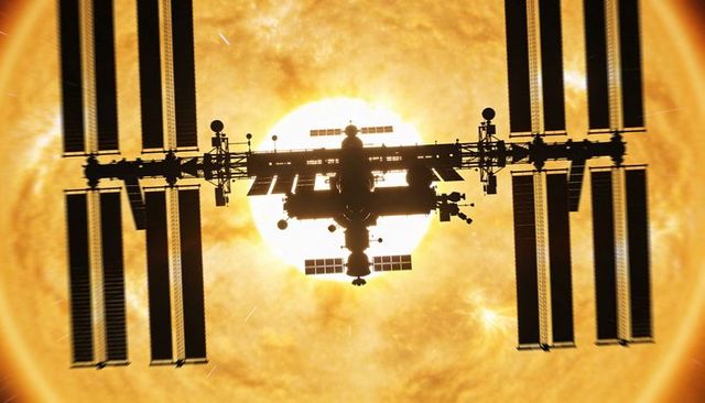 Modular Space Station Sailing Past Sun with Long Solar Arrays in Dramatic Silhouette