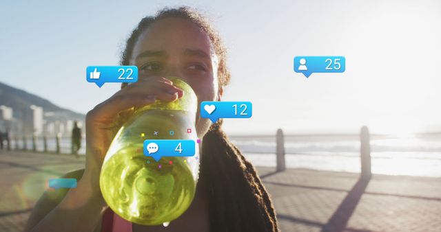 Athletic Woman Drinking Water Bottle with Social Media Likes Counter on Seaside Promenade - Download Free Stock Images Pikwizard.com