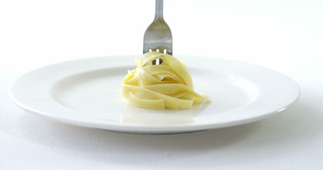 Close-up of cooked pasta on plate with fork