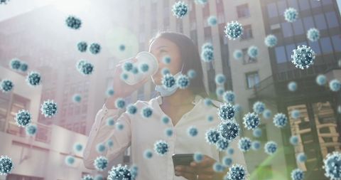 Masked woman drinking coffee surrounded by covid-19 cells concept