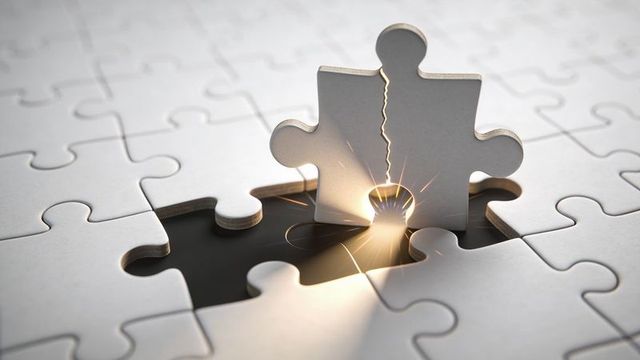 Upright Jigsaw Puzzle Piece Emitting Light Sparks Over Empty Slot Symbolizing Breakthrough