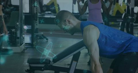 Man Strength Training with Dumbbells at Gym in Sportswear