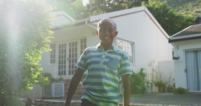 Smiling Boy Standing Outside Modern House in Sunlight - Download Free Stock Images Pikwizard.com