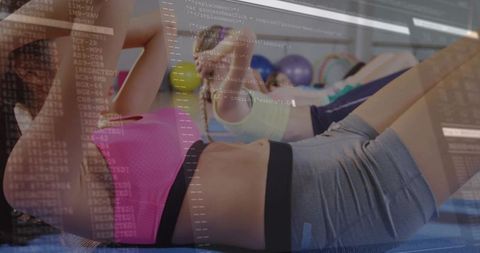 Women performing core workout on mats with stability balls and digital code overlay