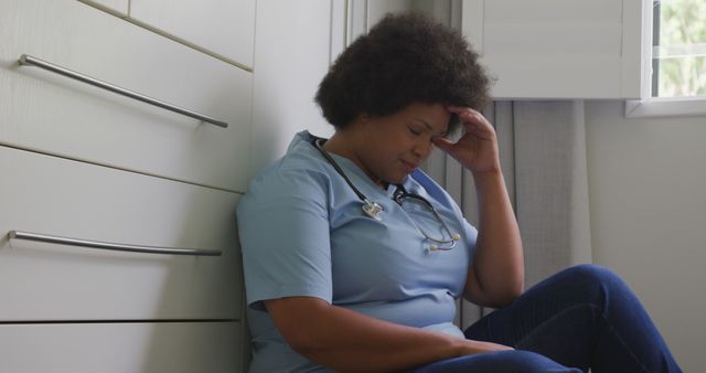 Image of tired plus size african american female doctor resting at social room. health, medicine and doctor profession.