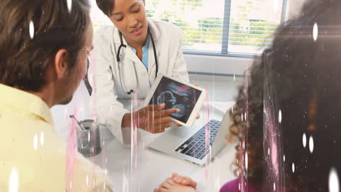 Doctor Showing Ultrasound to Expectant Couple with Holographic Interface