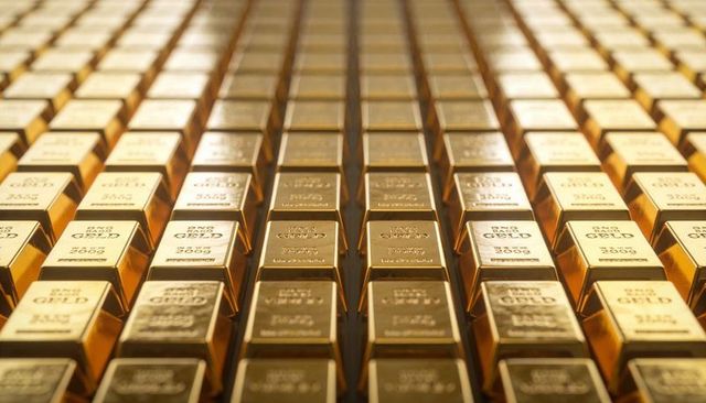 Gleaming gold bullion bars lining vault in symmetrical rows conveying wealth and security