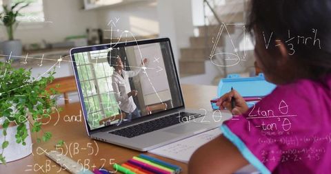 Child attentively learning geometry through online tutoring at home