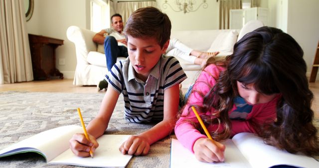 Young Siblings Doing Homework Together in Living Room - Download Free Stock Images Pikwizard.com