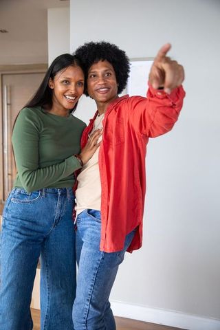 Happy Couple Exploring New Home in Casual Style