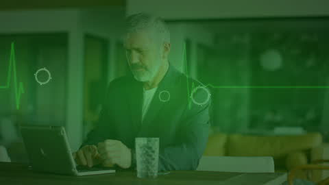 Senior Businessman Using Laptop with Digital Heartbeat Overlay