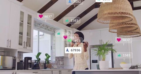Woman live streaming from modern farmhouse kitchen with social media engagement overlays