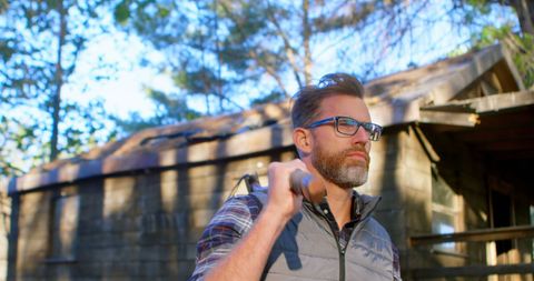 Caucasian Man Holding Shovel Outdoors Near Rustic Cabin - Download Free Stock Images Pikwizard.com