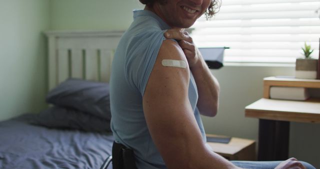 Young Man Showing Bandage on Arm After Vaccination in Bedroom - Download Free Stock Images Pikwizard.com