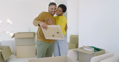 Couple Unpacking Together in New Home Living Room