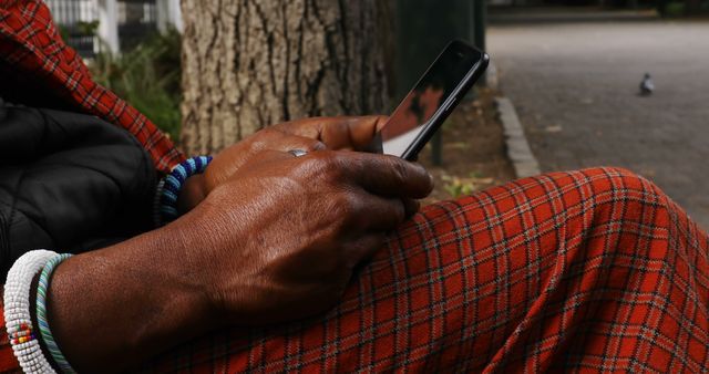 Close-up of person texting on smartphone with red checked cloth - Download Free Stock Images Pikwizard.com