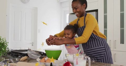 Joyful Mother and Daughter Cooking Together at Home