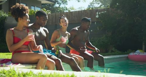 Diverse Group Enjoying Summer by Backyard Pool Side