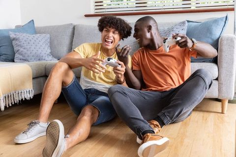 Friends Enjoying Video Game Challenge at Home