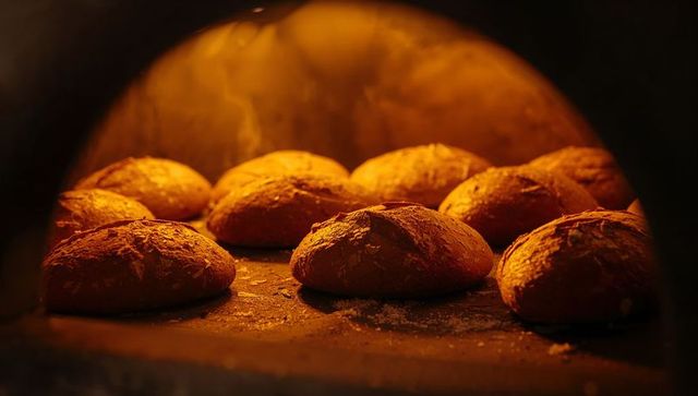 Rustic artisan loaves baking in traditional stone oven