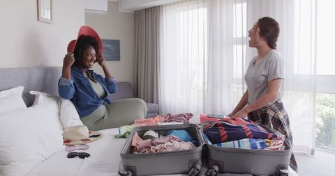 Happy Lesbian Couple Preparing for Vacation at Home